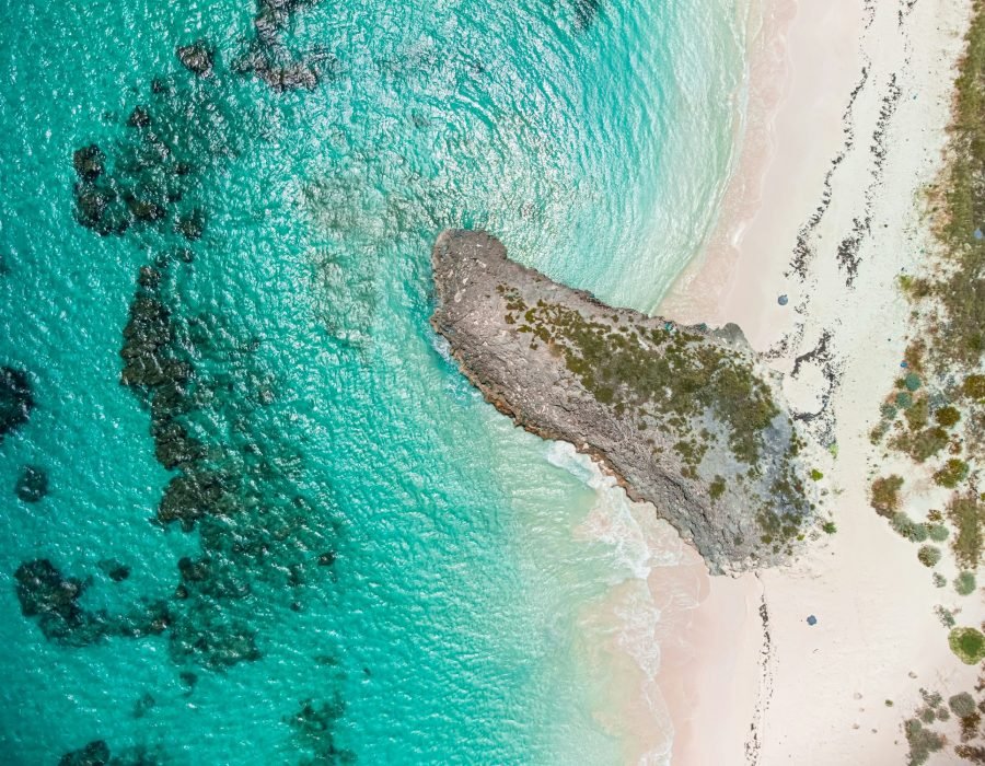 Aerial top view of a beautiful beach against turquoise sea in San Salvador, The Bahamas